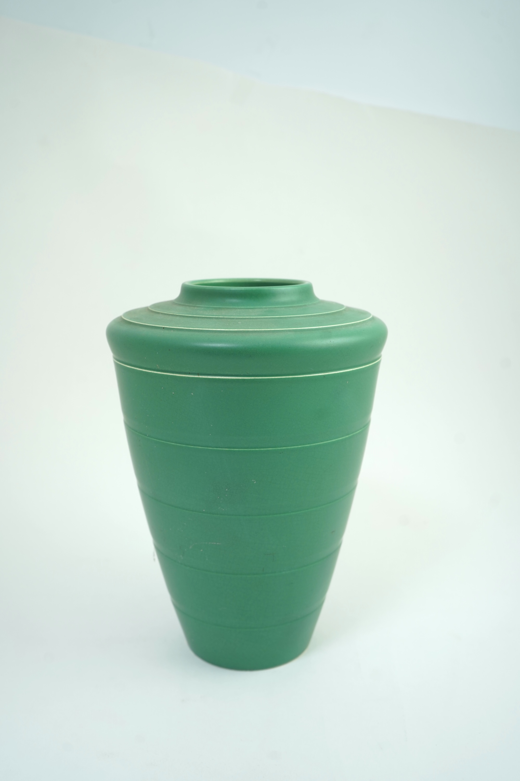 Keith Murray MC RDI FRIBA (New Zealand/British, 1892-1981) for Wedgwood: A matt green glazed tapering vase